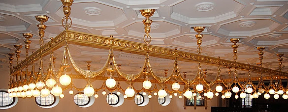 Jugendstilleuchter im Festsaal. Goldfarben mit kleinen weißen Kugeln Jugendstilleuchter im Festsaal. Goldfarben mit kleinen weißen Kugeln